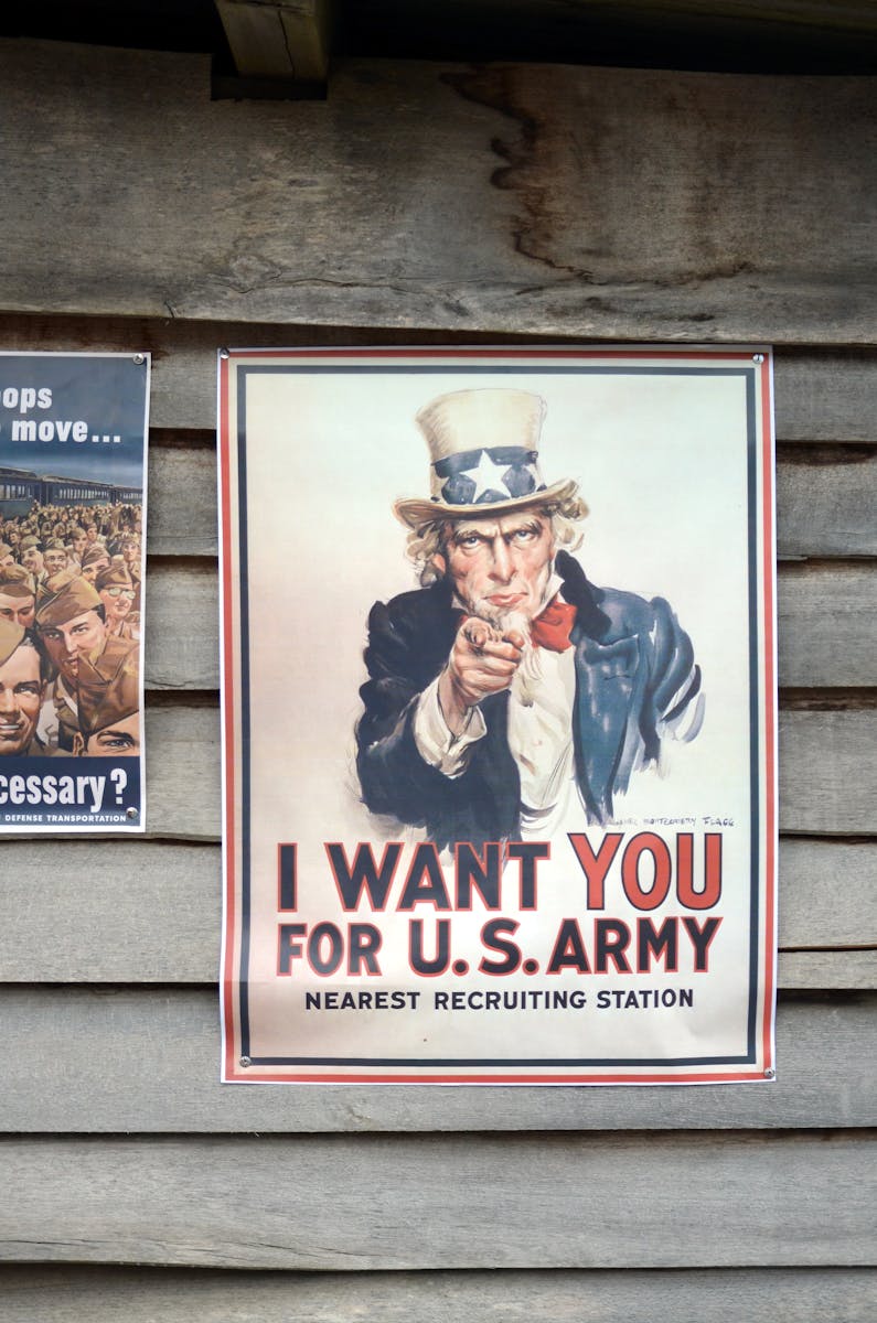 Photo by Inguaribile Viaggiatore Vintage US Army recruitment poster featuring Uncle Sam on a wooden wall.